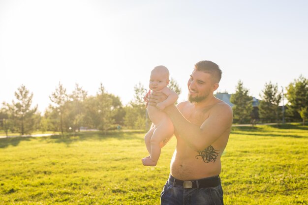 Full length of shirtless man standing on field