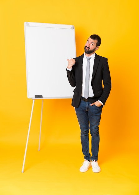 Full-length shot of businessman giving a presentation on white board 