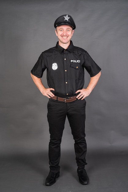 Full length shot of Caucasian man wearing police uniform costume