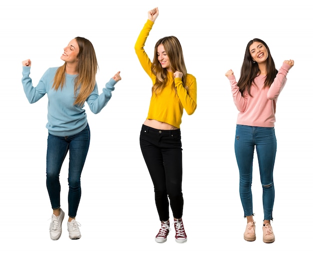 A full-length shot of a group of people with colorful clothes celebrating a victory