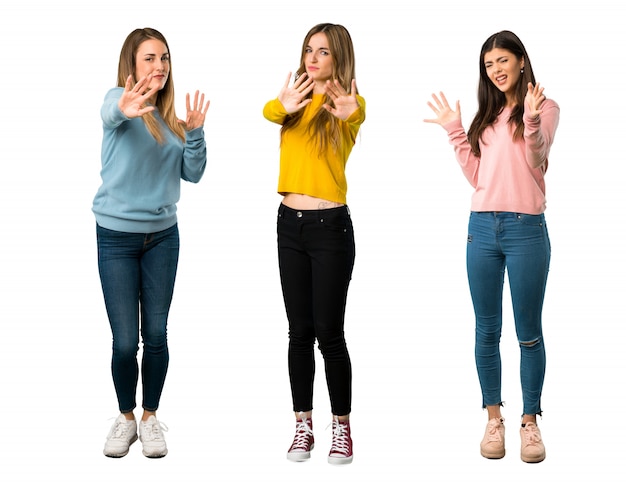 A full-length shot of a group of people with colorful clothes is a little bit nervous