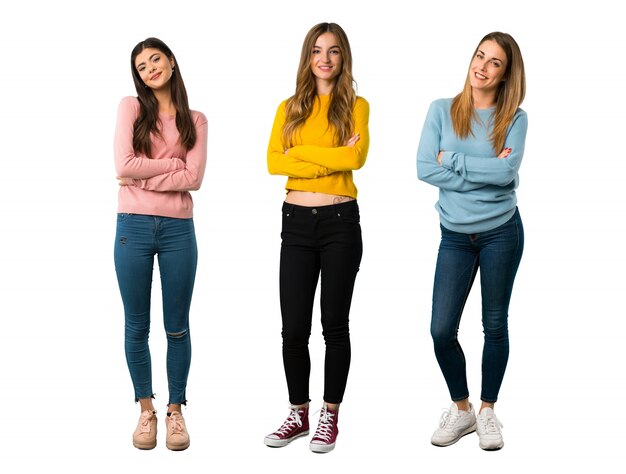 A full-length shot of a group of people with colorful clothes keeping the arms crossed 