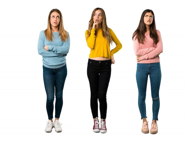 A full-length shot of a group of people with colorful clothes with confuse face expression 