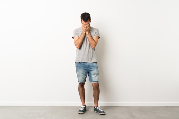 A full-length shot of handsome man with beard with tired and sick expression