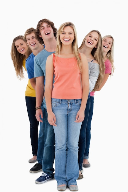 A full length shot of six people looking forward at various angles