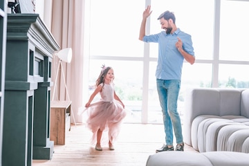 Premium Photo | Full length shot of small daughter and her dad dancing at home together