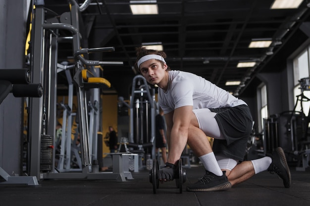 Full length shot of a sportsman looking focused exercising with dumbbells