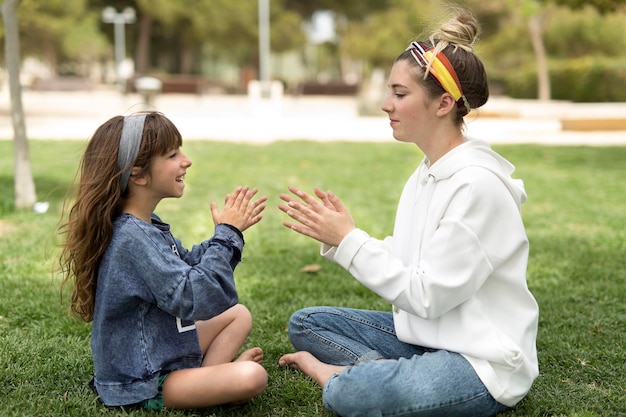 Photo full length of siblings playing on field at park