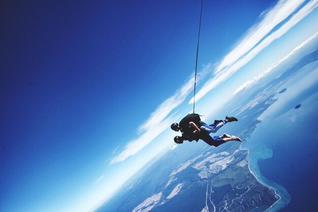 Photo full length side view of people skydiving