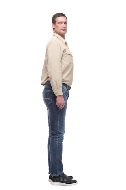 Full length side view portrait of serious man in jeans