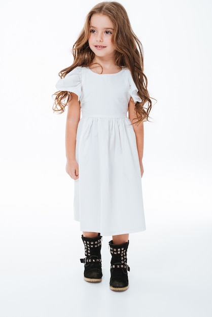 Full length of smiling beautiful little girl in dress walking