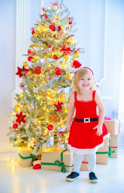Full length of smiling woman with christmas tree