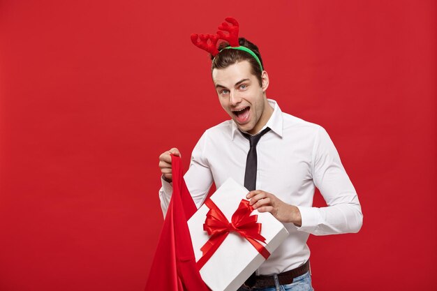 Full length of a smiling young man against red background