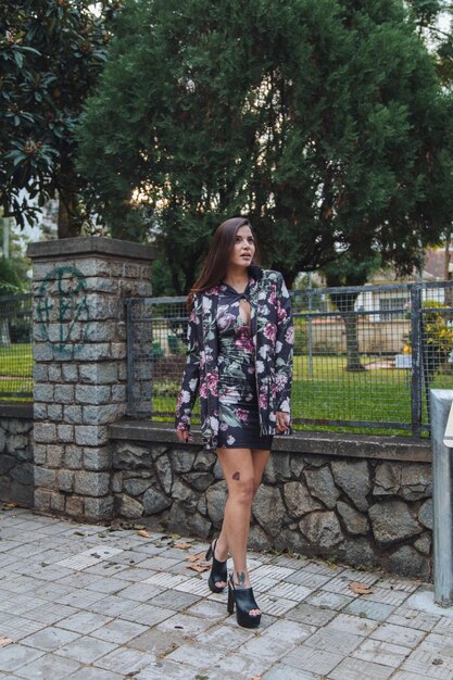 Full length of smiling young woman against tree