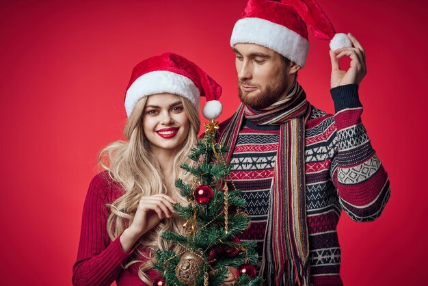 Full length of smiling young woman in illuminated christmas tree during winter