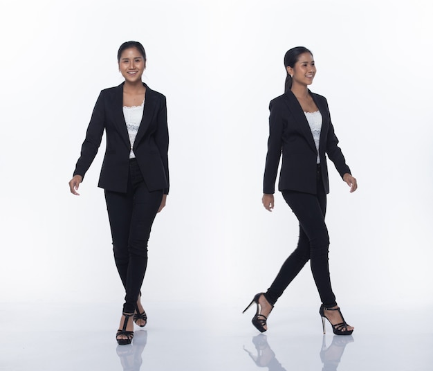 Full Length Snap Figure, Asian Business Woman Stand in black Formal proper Suit pants and shoes, studio lighting white background isolated, Lawyer Boss act posing smile smart look walking high heels