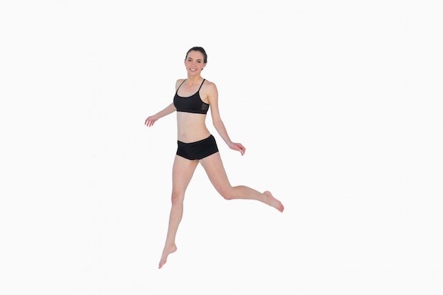 Full length of a sporty young woman jumping