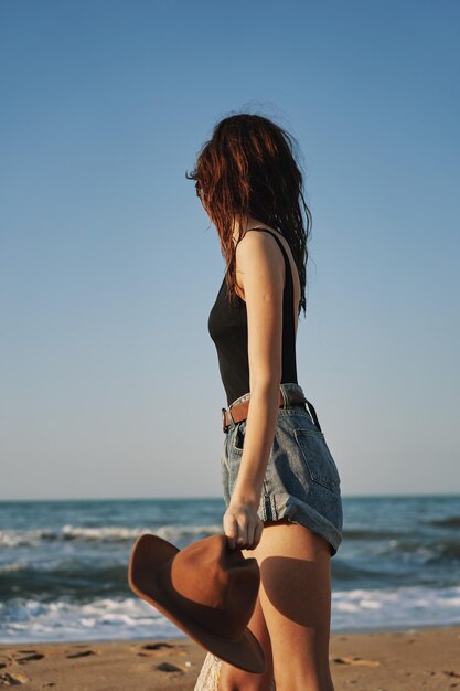 Full length of woman at beach against clear sky