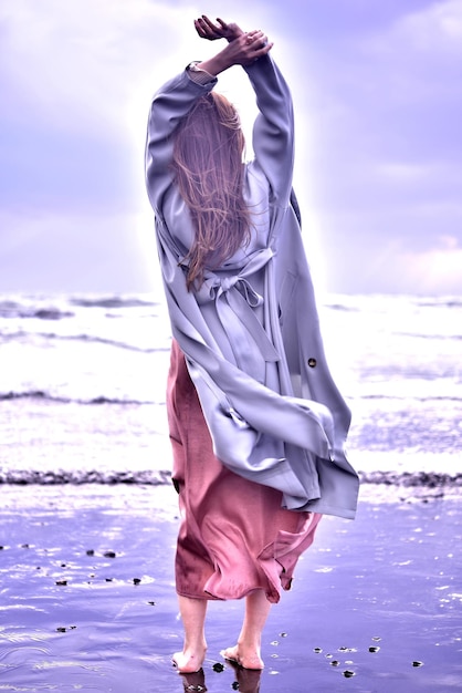 Full length of woman on beach against sky