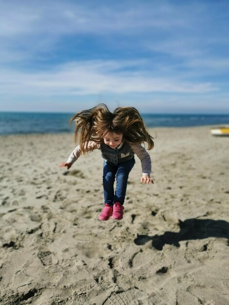 Full length of woman on beach against sky