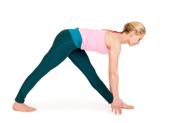 Full length of woman exercising against white background