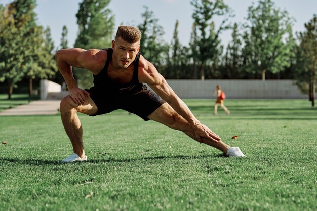 Full length of woman exercising on field