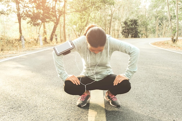 Full length of woman exercising on road