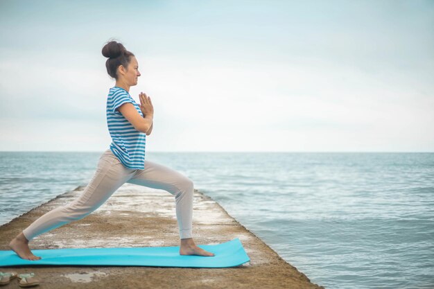 Full length of woman exercising in sea