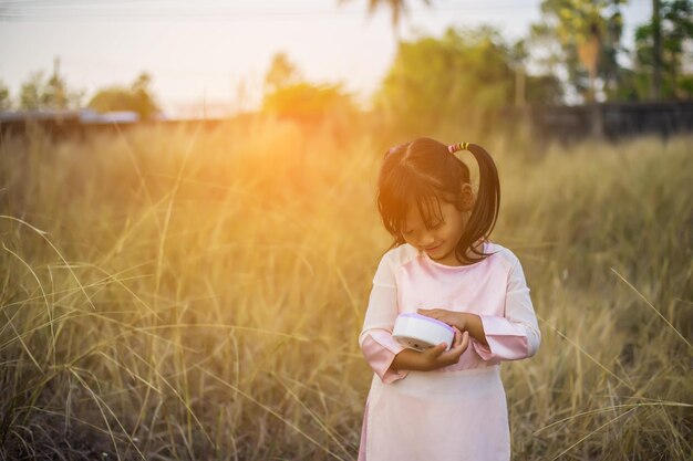 Photo full length of woman holding girl standing on field