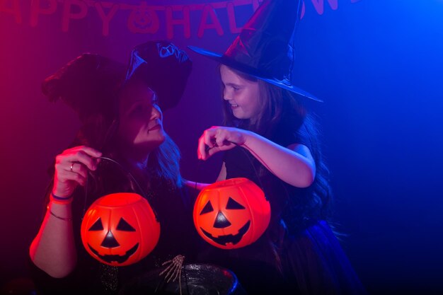 Photo full length of woman holding pumpkin at night