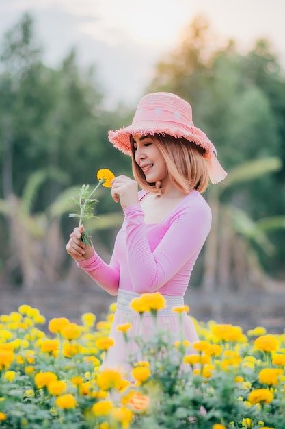 Full length of woman holding yellow flowers