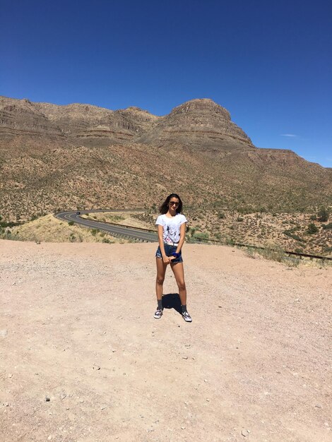 Full length of woman on mountain against clear sky