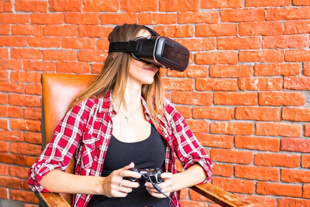 Full length of woman photographing against brick wall