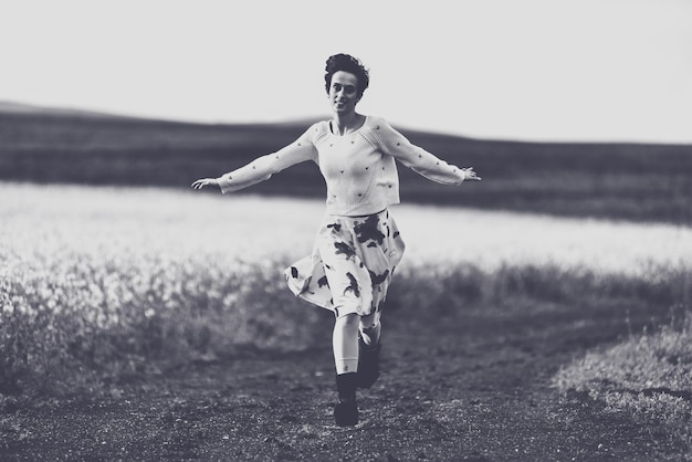 full length of woman running on field