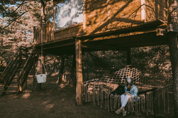 Full length of woman sitting in hammock