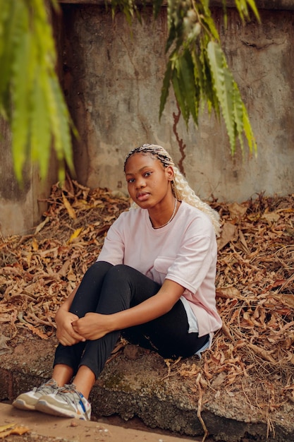 full length of woman sitting on land outdoors