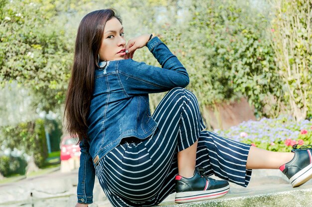 Full length of woman sitting outdoors