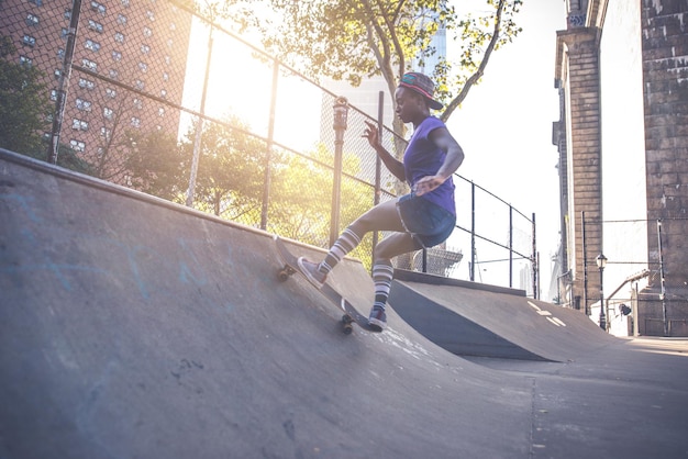 Full length of woman skateboarding at skateboard park