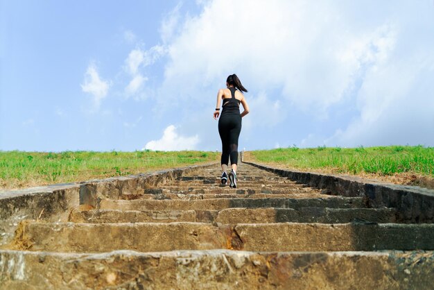 Full length of woman on staircase against sky