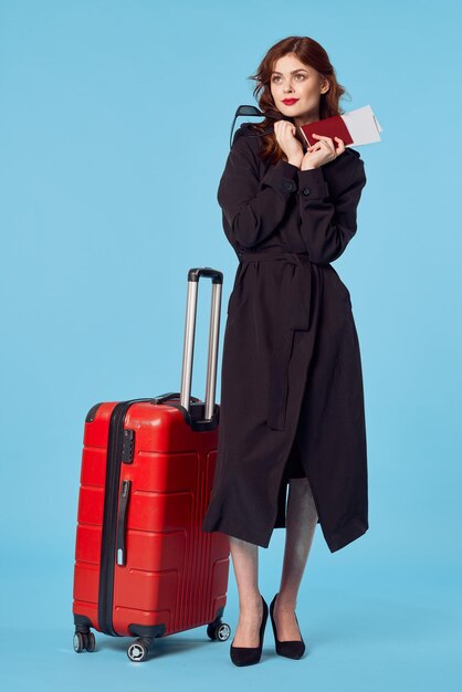 Full length of woman standing against blue background