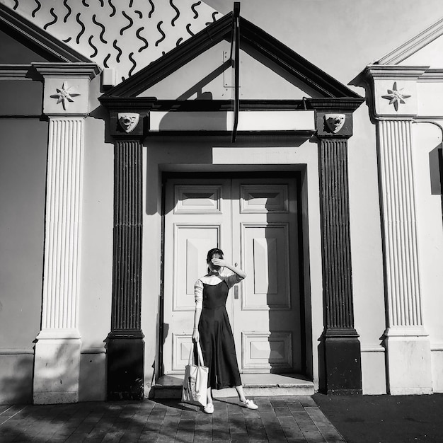 Photo full length of woman standing against building