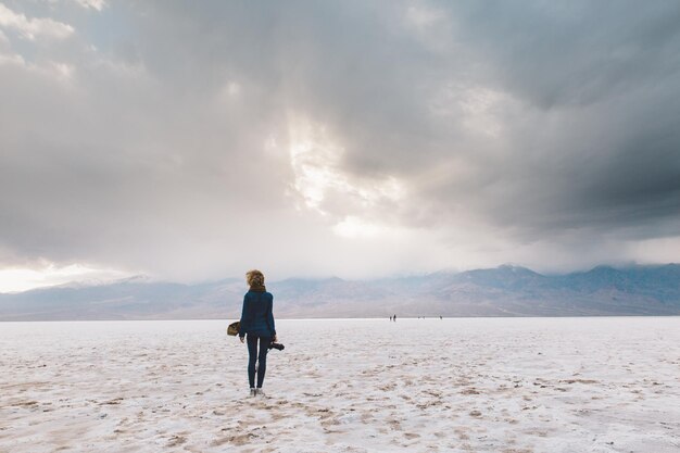 Full length of woman standing against sky