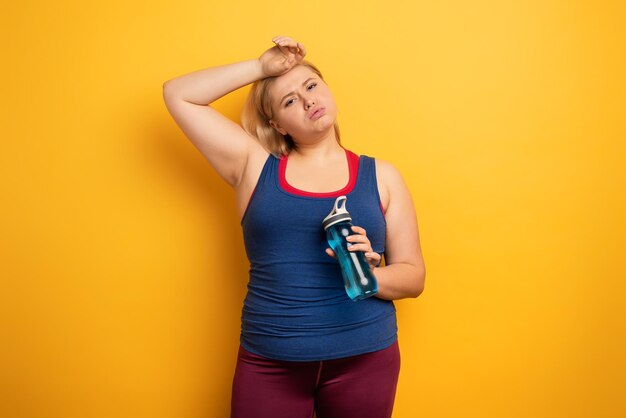 Full length of woman standing against yellow background