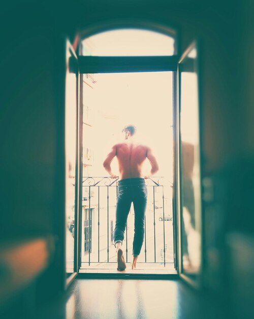 Full length of woman standing by railing