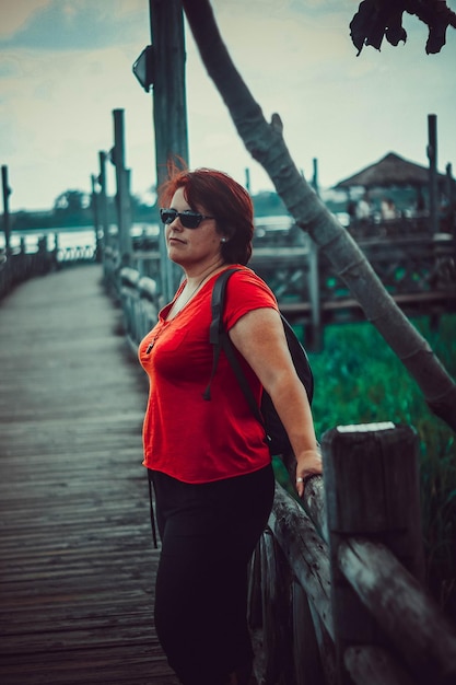 Full length of woman standing by railing