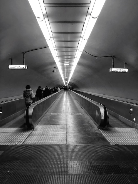 Full length of woman standing on escalator