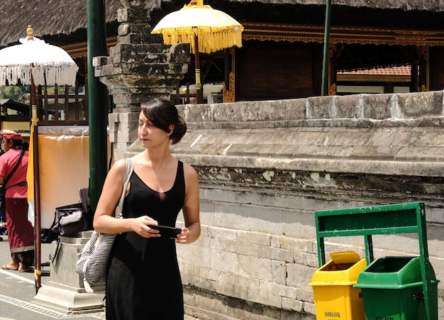 Full length of woman standing on mobile phone