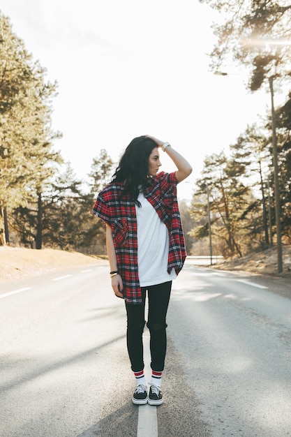 Full length of woman standing on road against sky