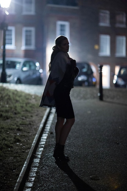 Photo full length of woman standing on street in city