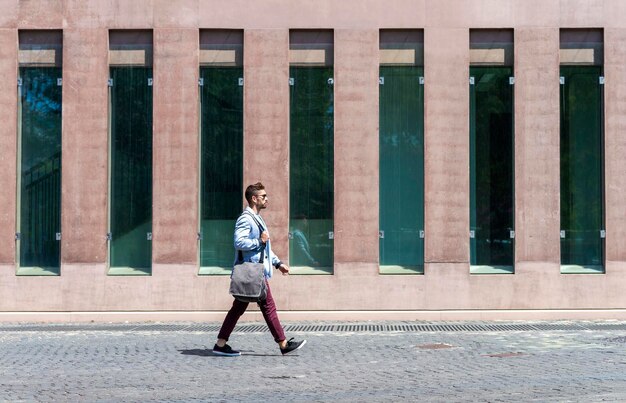 Full length of woman walking on footpath in city